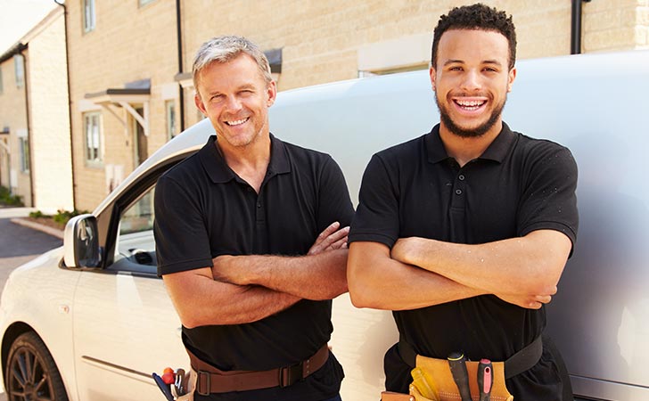 Two workers happy they have vehicle finance